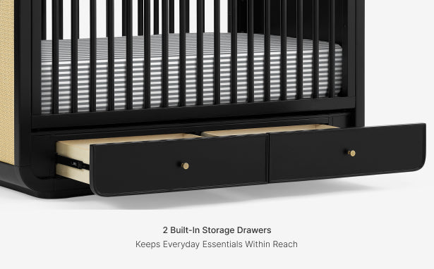 Black crib with two built-in storage drawers on a white background
