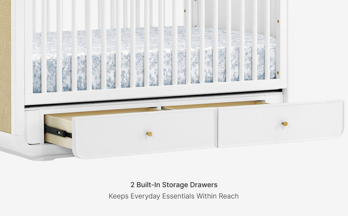 White crib with built-in storage drawers on a white background