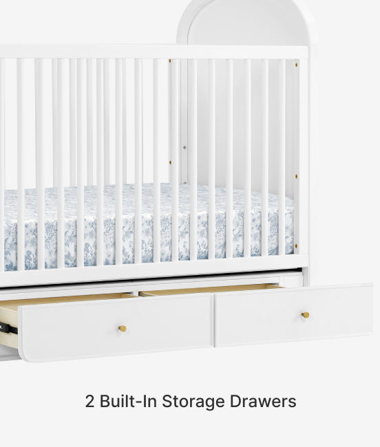 White crib with two built-in storage drawers on a white background
