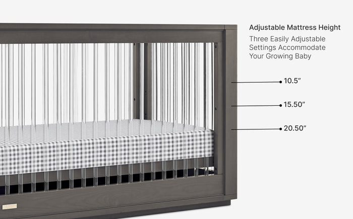 Crib with adjustable mattress height settings labeled on a white background