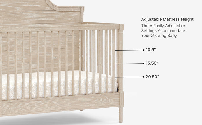 Beige crib with adjustable mattress height settings on a white background