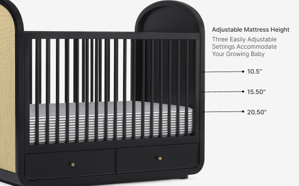 Black crib with adjustable mattress height settings on a white background