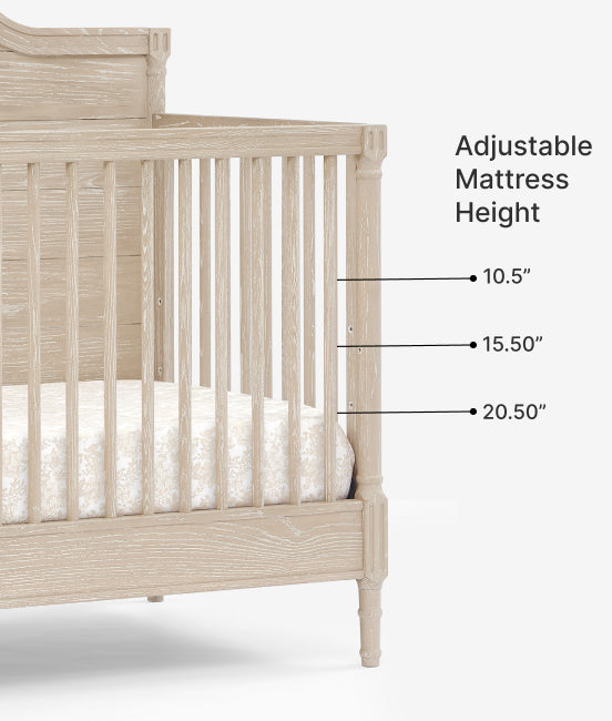 Beige crib with adjustable mattress height labels on a white background