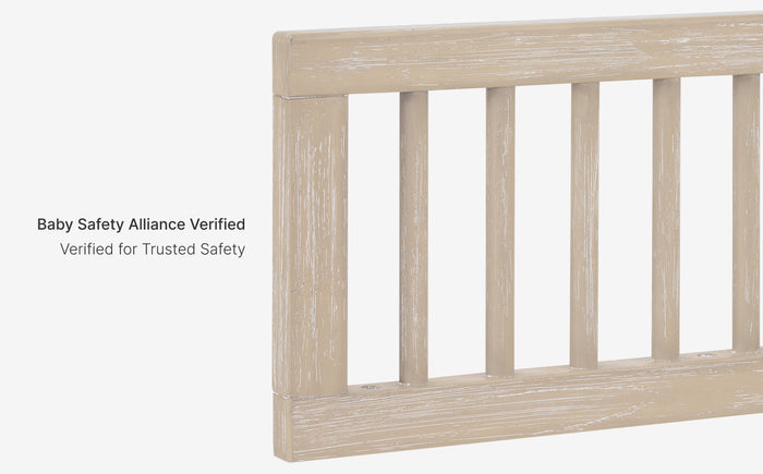 Wooden crib railing with 'Baby Safety Alliance Verified' text on a white background