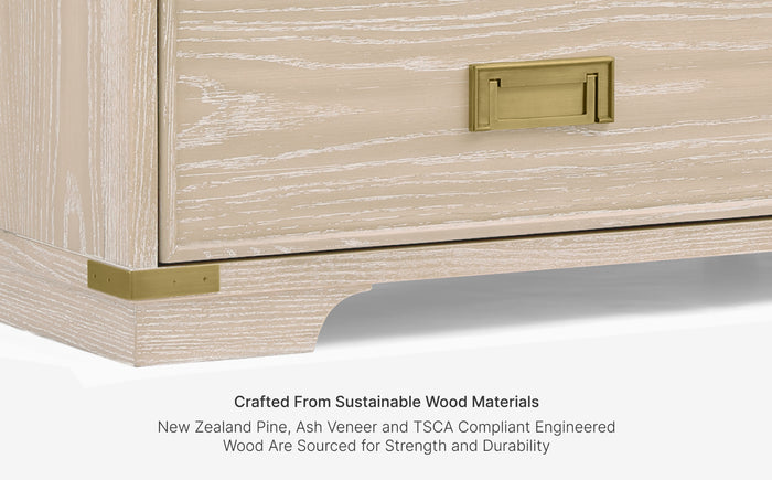 Wooden drawer with gold handle on a white background, highlighting sustainable wood materials.