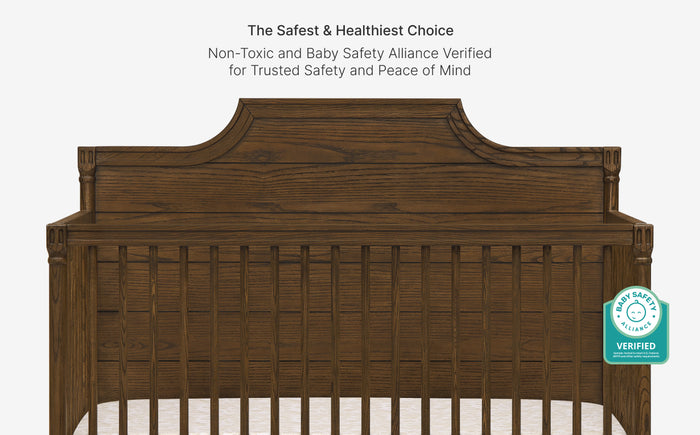 Wooden crib with safety certification badge on a white background