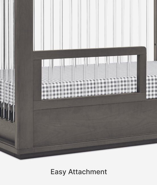 Gray crib with a checkered mattress and 'Easy Attachment' text on a white background