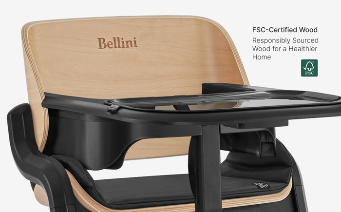 Child seat with wooden backrest and black tray, featuring the brand 'Bellini'.