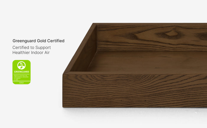 Wooden tray with Greenguard Gold certification label on a white background