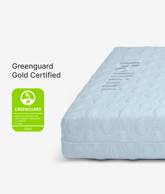 Blue mattress with Greenguard Gold Certified label on a white background