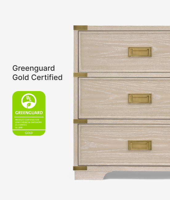 Wooden dresser with gold handles and Greenguard Gold certification logo on a white background