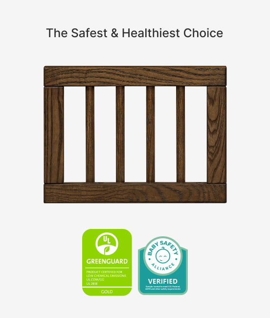 Wooden crib with GreenGuard and Baby Safety Alliance certification logos on a white background