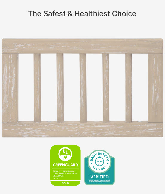Wooden crib with GreenGuard and Baby Safety Alliance certification logos on a white background