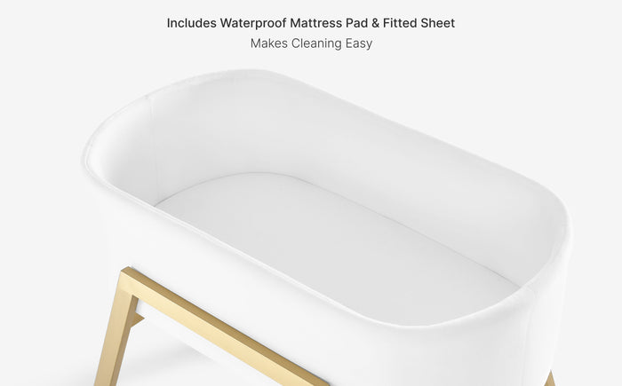 White crib with gold legs on a white background