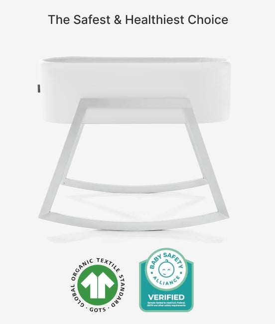 White crib with safety certification logos on a white background