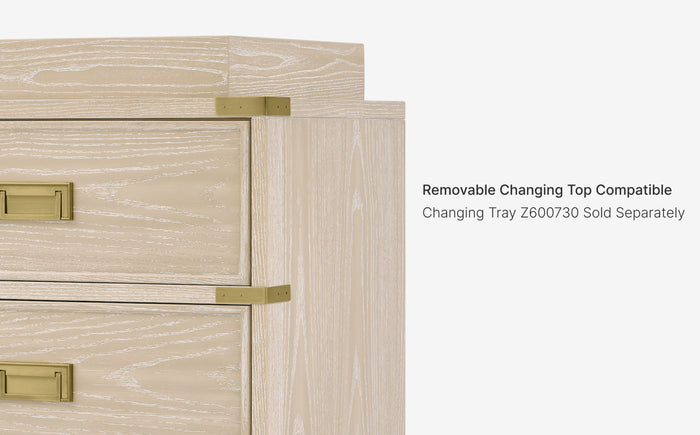 Wooden changing table with gold hardware on a white background