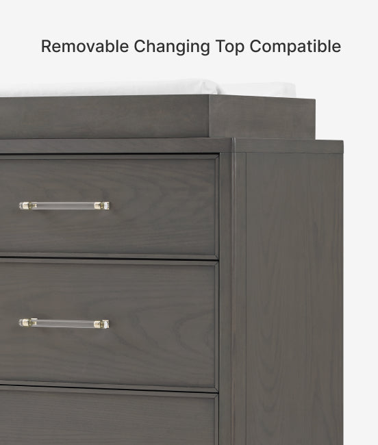 Gray dresser with clear handles on a white background