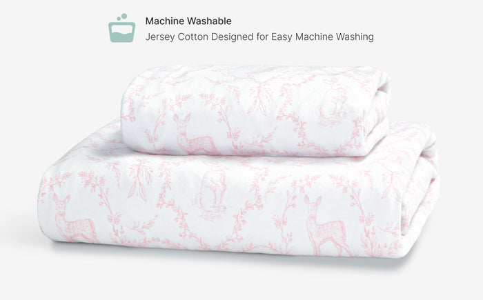 Folded jersey cotton fabric with pink floral pattern on a white background
