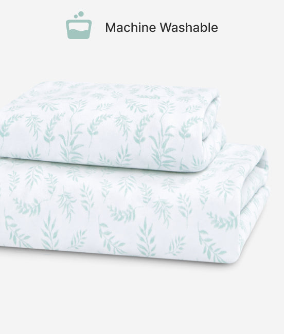 Folded fabric with a leaf pattern on a white background, labeled 'Machine Washable'.