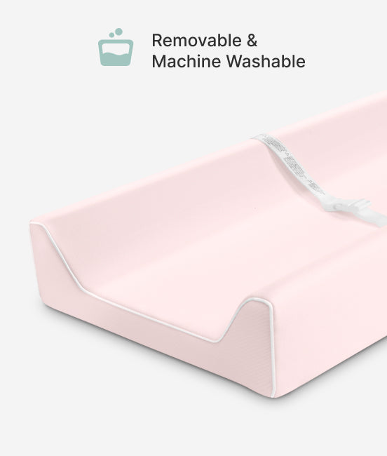 Pink mattress protector with text 'Removable & Machine Washable' on a white background