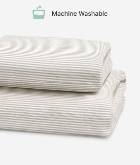 Folded striped fabric with 'Machine Washable' icon on a white background
