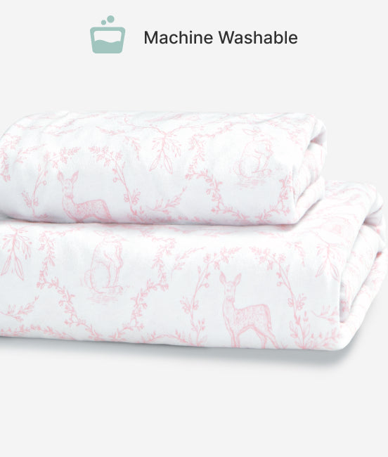 Folded fabric with pink floral pattern on a white background, labeled 'Machine Washable'.