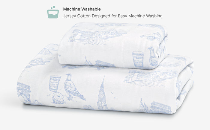Folded jersey cotton sheet with blue bird pattern on a white background