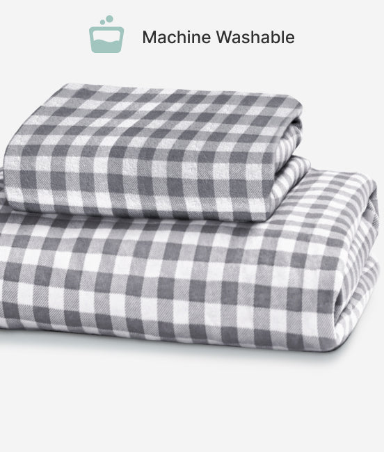 Folded gray and white checkered fabric with 'Machine Washable' label on a light background