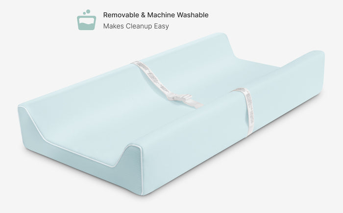 Light blue changing pad with text indicating it is removable and machine washable.