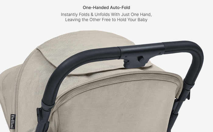 Beige baby stroller with black handle on a light gray background