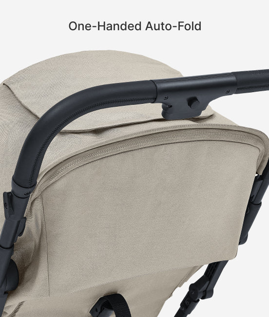 Beige stroller with one-handed auto-fold feature on a white background