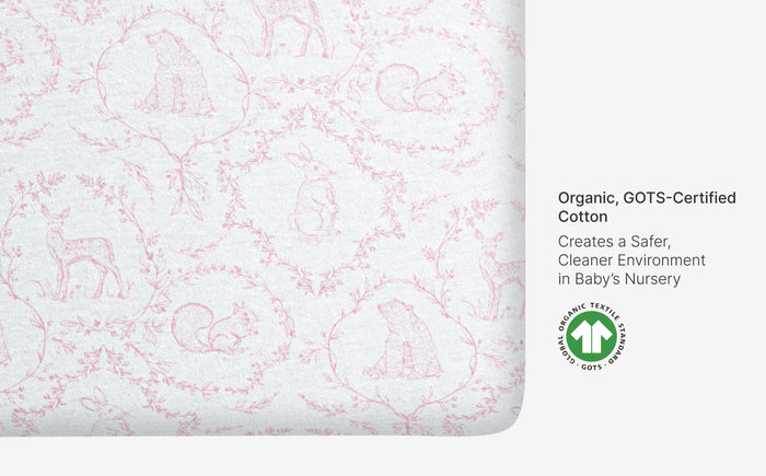 Textured fabric with red patterns on a white background, featuring GOTS certification logo.