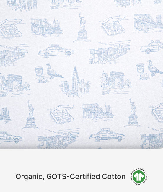 Patterned fabric with blue line drawings on a white background, featuring GOTS-Certified Cotton label.