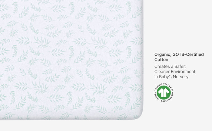 Organic cotton sheet with leaf pattern and GOTS certification logo on a white background
