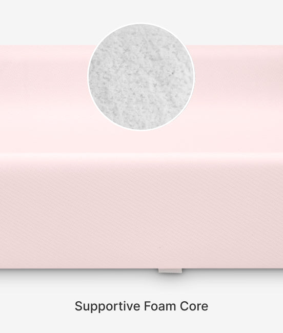 Close-up of a pink product with a circular inset showing supportive foam core on a white background.