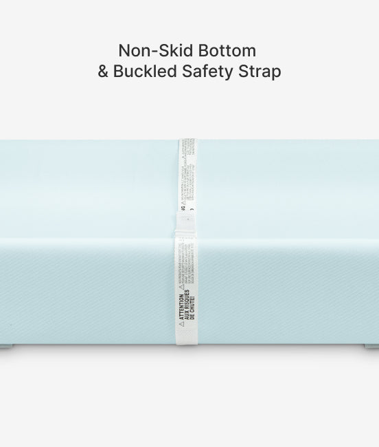 Light blue mat with a buckled safety strap on a white background