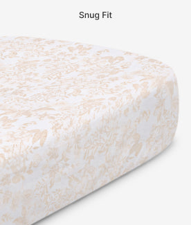 Fitted sheet with a subtle pattern on a mattress, labeled 'Snug Fit'.