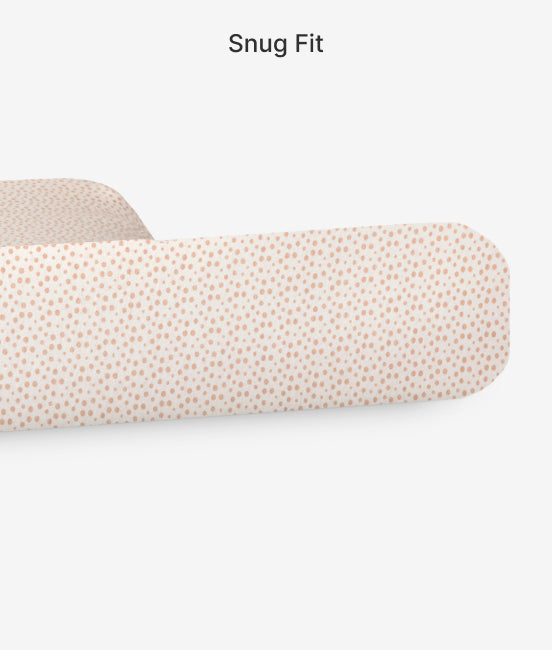 Fitted sheet with subtle pattern on a bed, labeled 'Snug Fit'.