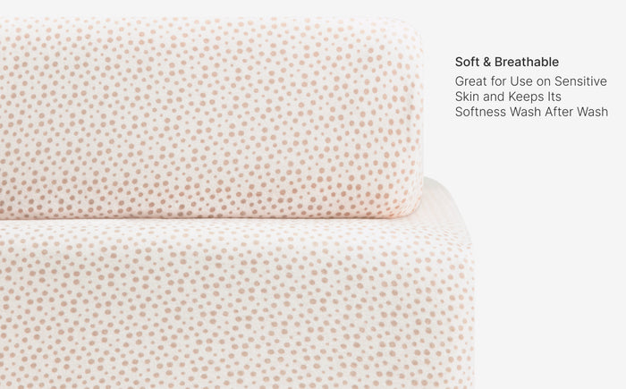 Textured fabric with a subtle pattern on a white background, featuring text about softness and breathability.
