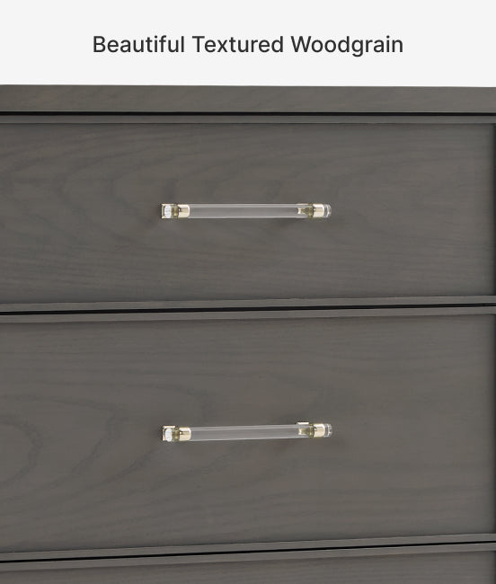 Gray dresser with clear glass handles on a light gray background