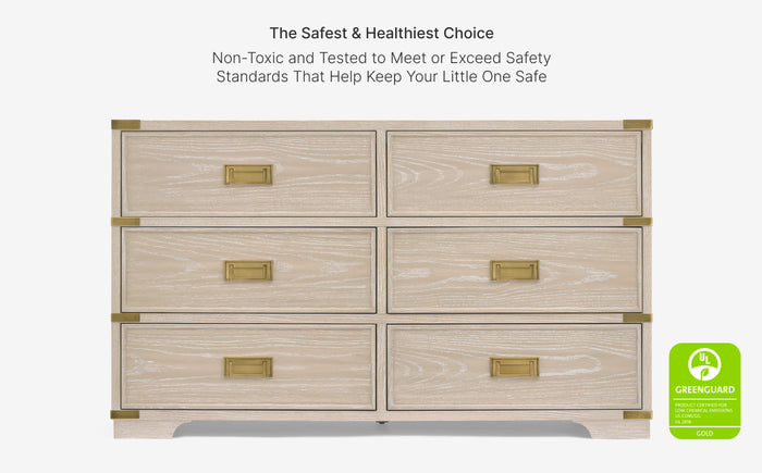 Wooden dresser with gold accents on a white background, featuring safety certification text and a GreenGUARD logo.
