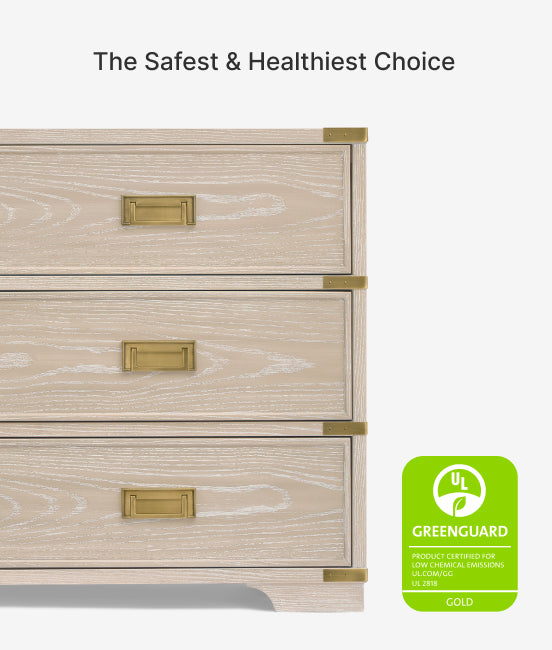 Wooden dresser with gold handles and Greenguard Gold certification label on a white background
