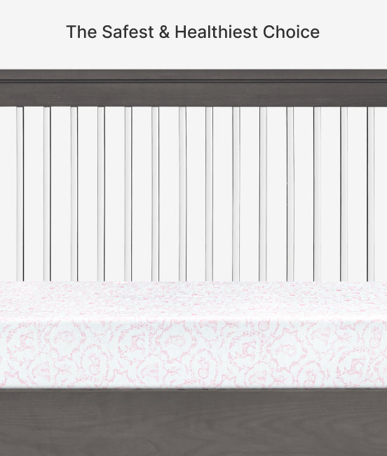 Crib with white mattress and decorative border, text 'The Safest & Healthiest Choice' at the top.