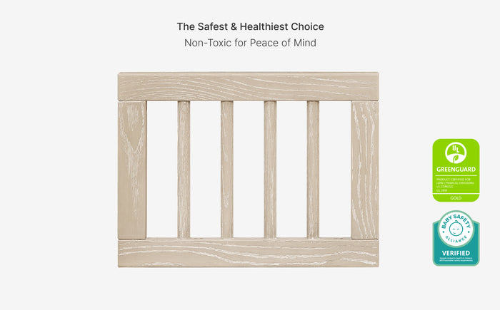 Wooden crib with green certification labels on a white background