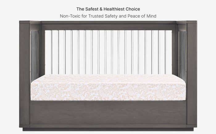 Crib with safety bars and mattress, labeled as the safest and healthiest choice.