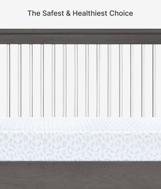 Crib with white bedding and gray sides, text 'The Safest & Healthiest Choice' at the top.
