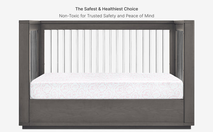 Gray crib with white mattress and text about safety and healthiness on a white background