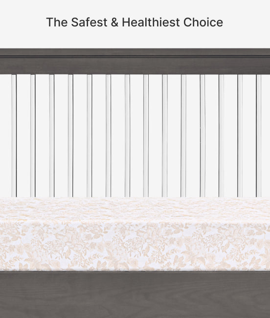 Crib with white mattress and wooden side, text 'The Safest & Healthiest Choice' at the top.