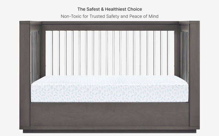 Crib with a mattress, emphasizing safety and healthiness on a white background.