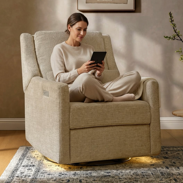 Woman sitting in a beige armchair using a tablet in a cozy living room.